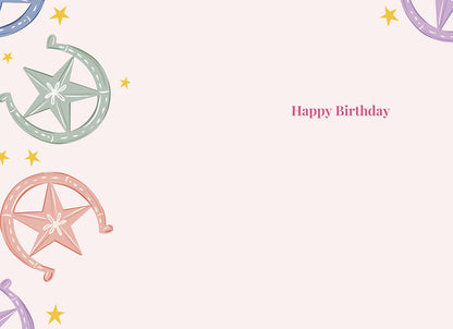 Inside of the "Sparkle & Shine" card, blank with colorful horseshoe and star pattern, text "Happy Birthday".