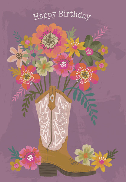 Front of a card featuring a cowboy boot overflowing with colorful flowers, text "Happy Birthday" on a purple background.