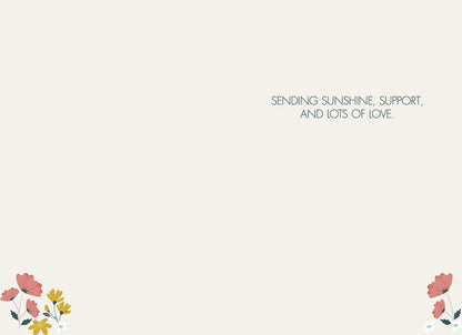 Inside of the "BLOOM WITH GRACE" card, with small floral accents, text: "SENDING SUNSHINE, SUPPORT, AND LOTS OF LOVE.".