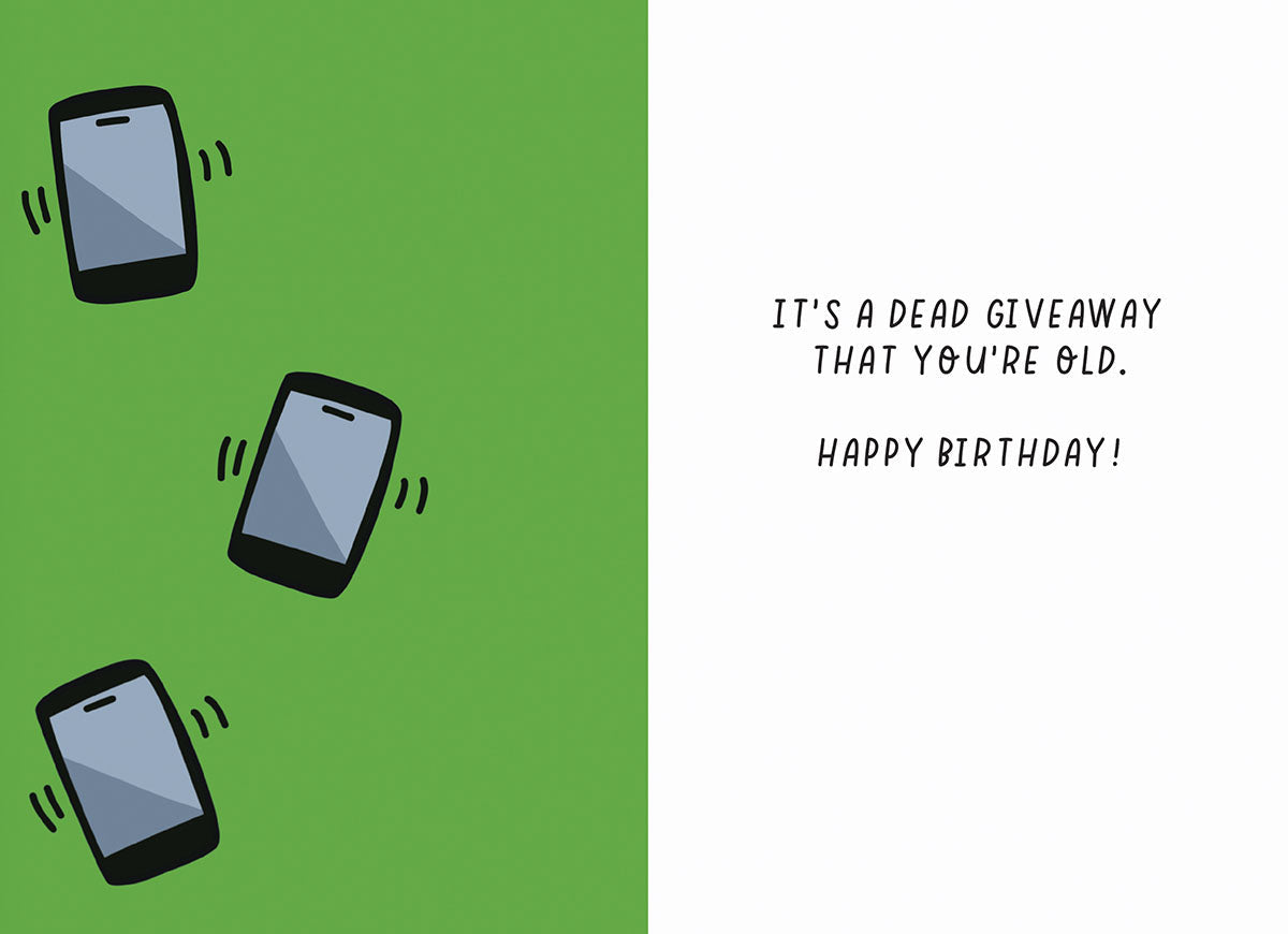 Inside of humorous birthday greeting card. Reads 'IT'S A DEAD GIVEAWAY THAT YOU'RE OLD. HAPPY BIRTHDAY!' Three simple mobile phone illustrations are on a green background to the left.