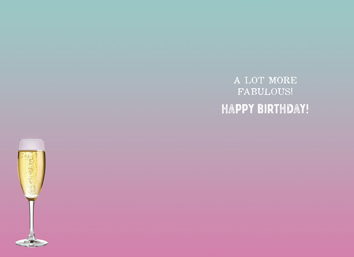 Inside of a lighthearted greeting card featuring a single champagne flute on a pink to blue gradient background, with the festive message 'A LOT MORE FABULOUS! HAPPY BIRTHDAY!'.