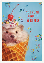 Greeting card front featuring an adorable hedgehog in a waffle ice cream cone with whipped cream, colorful sprinkles, and a red cherry on top. Bold red text reads 'YOU'RE MY KIND OF WEIRD' against a light blue background with scattered sprinkles. Ideal for a quirky friend or sibling's birthday.