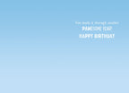 Inside of a humorous greeting card with a light blue sky background, displaying the message 'You made it through another PAWESOME YEAR! HAPPY BIRTHDAY' in playful white font.