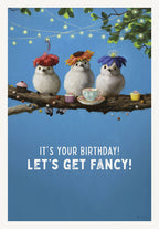 Cute bird birthday card featuring three fluffy white birds in elaborate floral hats, perched on a branch with cupcakes and a teacup, against a vibrant blue sky background. The card front reads 'IT'S YOUR BIRTHDAY! LET'S GET FANCY!'. Perfect for a friend or child's celebration.