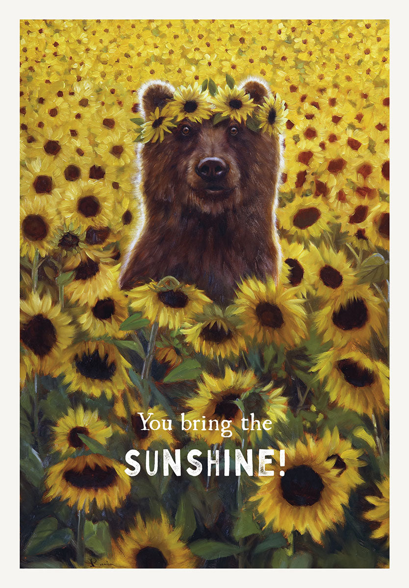 Cute brown bear wearing a sunflower crown in a vibrant yellow sunflower field, with the text 'You bring the SUNSHINE!' on a greeting card.