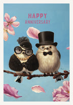Romantic anniversary card featuring two elegantly dressed birds, a male in a top hat and a female in pearls, sitting on a branch with pink petals, 'Happy Anniversary' text.