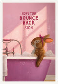 Cute bunny in a pink bubble bath with a polka dot headscarf, a 'Hope You Bounce Back Soon' greeting card. Ideal for someone recovering or needing a cheerful lift.