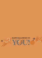 Inside of an orange Halloween greeting card featuring "HAPPY HALLOWEEN TO YOU!" at the bottom, accented with fall leaves, berries, and a small pumpkin.