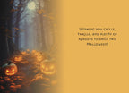 Inside of a themed greeting card featuring a mysterious forest path lined with glowing jack-o-lanterns and the message: 'Wishing you chills, thrills, and plenty of reasons to smile this Halloween!'