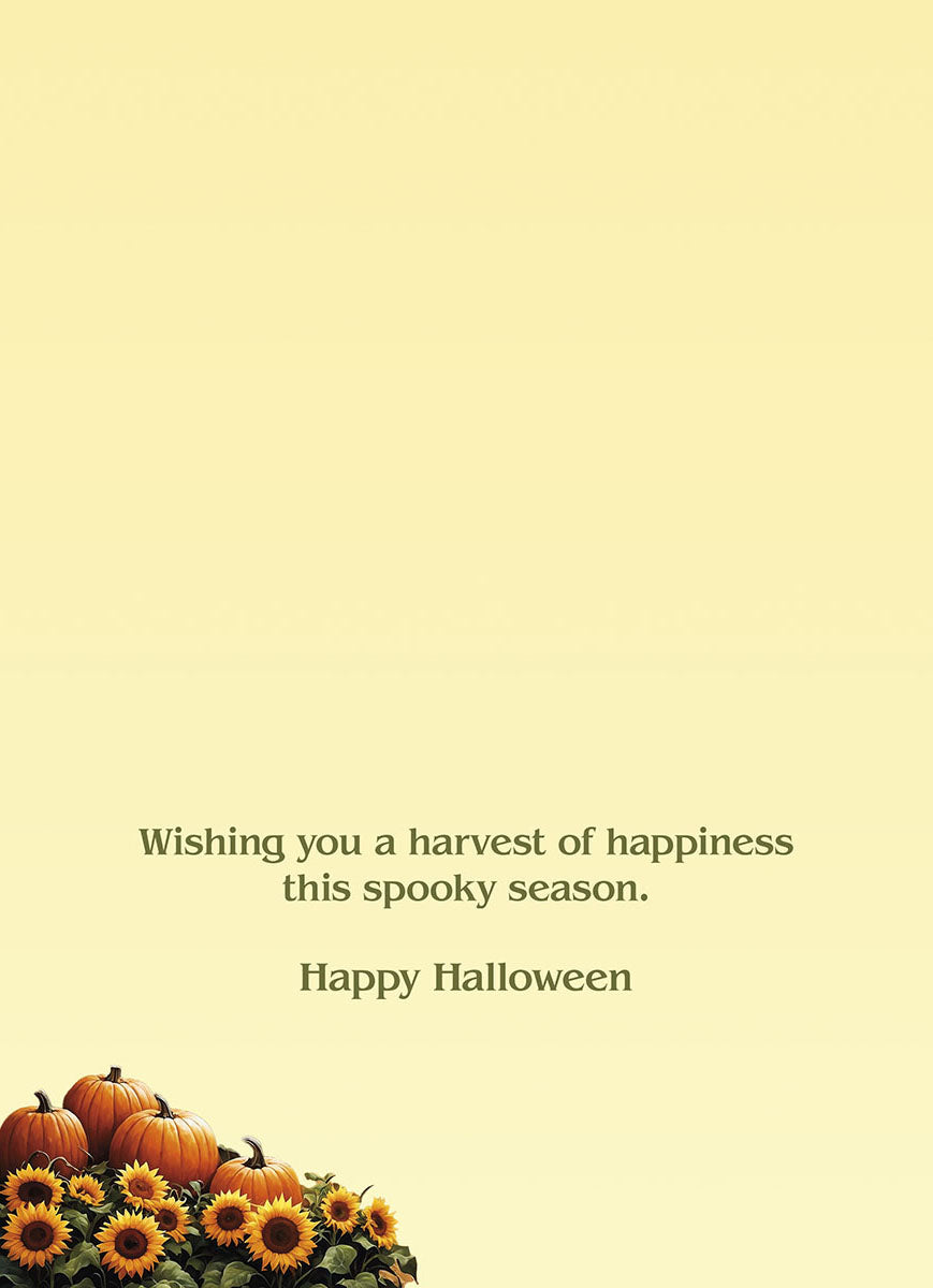 Inside of a light yellow greeting card featuring the message 'Wishing you a harvest of happiness this spooky season. Happy Halloween' and a decorative bottom corner with autumn pumpkins and sunflowers.