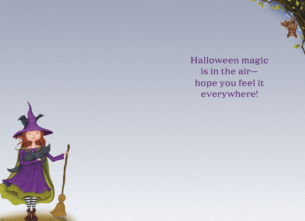 Open greeting card showing the cute witch illustration on the left and the message 'Halloween magic is in the air— hope you feel it everywhere!' on the right, with a small bat and leaf detail.