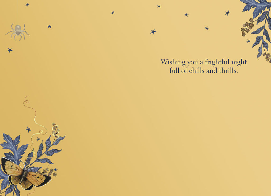 Inside of a mystical greeting card displaying a golden background with 'Wishing you a frightful night full of chills and thrills' text, adorned with dark foliage, golden berries, and a butterfly.