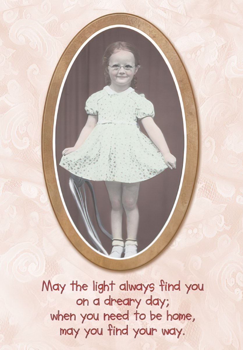 Close-up of a Maggie Mae card featuring a little girl in a white dress with the message 'May you find your way'.