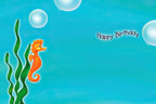 Inside of a blue children's birthday card with a small orange seahorse and green seaweed on the left. The text "Happy Birthday" is written on the right side of the card, with ample space for a personalized message. The background mimics an underwater scene with floating bubbles.