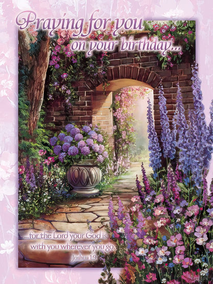 Greeting card front with a flowered archway and garden path, featuring "Praying for you on your birthday."