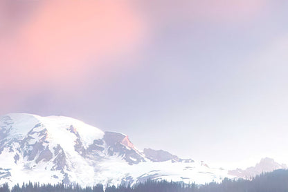 Blurred background with soft pink and purple tones, suggesting a cloudy sky over a snowy mountain range.