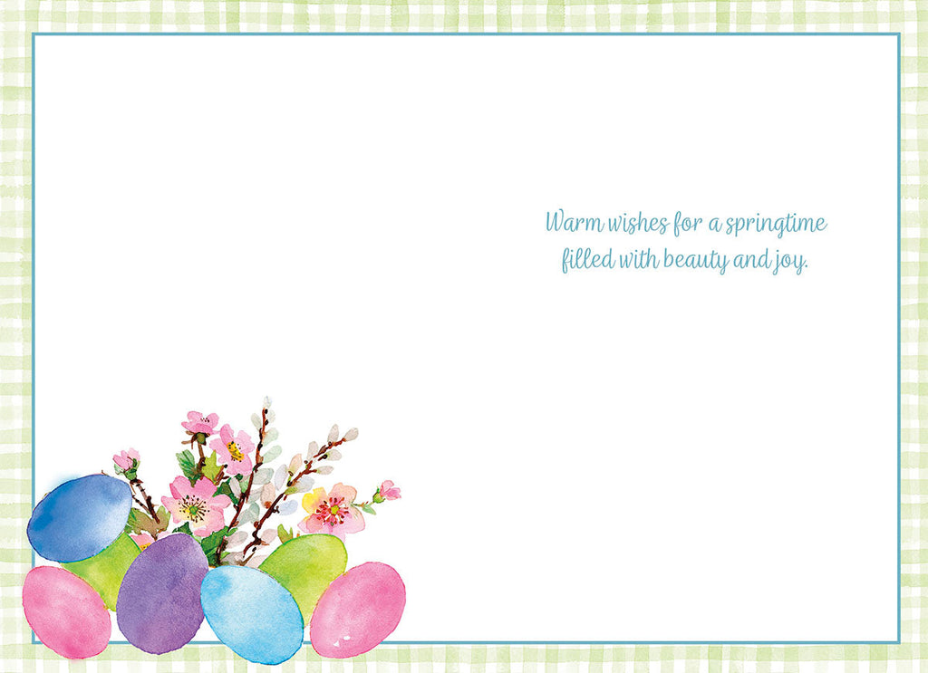 Inside view of a joyful spring greeting card with a thoughtful message 'Warm wishes for a springtime filled with beauty and joy.' and decorative watercolor pastel eggs and blooming spring flowers in the bottom left corner, bordered by a soft green gingham pattern.