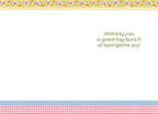 Inside of a simple white Easter greeting card displaying the message 'Wishing you a great big bunch of springtime joy!' centered on the right panel. The card features a decorative border mirroring the front, with small colorful flowers, blue polka dots, and a red and white gingham check pattern.