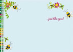 Inside of a cute Easter card for children, with '...just like you!' message, adorned with cheerful bees and colorful floral corner designs on a light blue background.