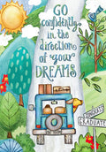 Front of a vibrant graduation greeting card featuring an illustration of a blue car packed with luggage, a dog looking out, driving on a road towards a bright sun. Text reads 'GO confidently in the direction of your DREAMS.' Green trees and 'CONGRATS GRADUATE' road signs surround the scene, symbolizing a new journey and future success.