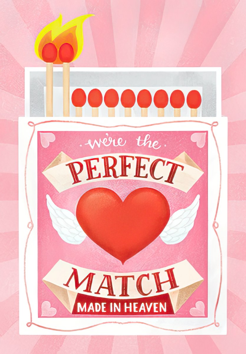 Front of a romantic greeting card featuring a pink matchbox design with two lit matches above. The matchbox text reads 'We're the PERFECT MATCH MADE IN HEAVEN' with a red heart and white wings.