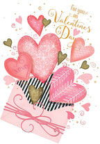 Front of a romantic Valentine's Day greeting card featuring numerous pink and gold glitter hearts spilling out of a decorative pink and black striped envelope, with the text 'For you on Valentine's Day' and 'XOXO' on a heart.