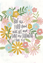 Close-up of a religious encouragement greeting card featuring a vibrant floral wreath design in pastel colors around the scripture 'But the Lord stood with me and gave me strength. 2 Tim. 4:17'.