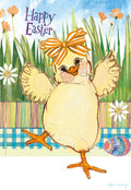 Front of a cheerful Easter greeting card featuring a fluffy yellow chick wearing an orange striped bow on its head, standing in a vibrant green grassy field with colorful flowers and a blue sky background. The text 'Happy Easter' is prominently displayed in purple script. An adorned Easter egg rests at the bottom.