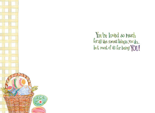 Inside of an adorable Easter greeting card for a child, showing a wicker basket filled with vibrant patterned eggs and a heartfelt message: 'You're loved so much for all the sweet things you do... but most of all for being YOU!'