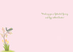 Inside of a cheerful spring greeting card with the message 'Wishing you a Splendid Spring and Egg-cellent Easter!' in green script, and a partial illustration of a bird on a flowering branch in the bottom left corner on a light pink background.