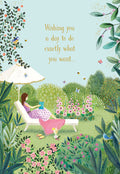 Elegant Mother's Day greeting card showing a peaceful garden scene with a woman relaxing in a lounge chair under an umbrella, reading a book amidst flowers, birds, and butterflies. Text reads: 'Wishing you a day to do exactly what you want...'