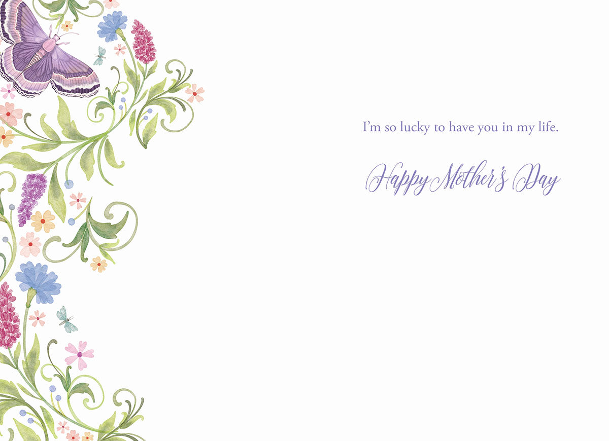 Inside of a greeting card with a floral border on the left, displaying a large purple moth wing and colorful flowers. Text on the right reads 'I'm so lucky to have you in my life. Happy Mother's Day'.