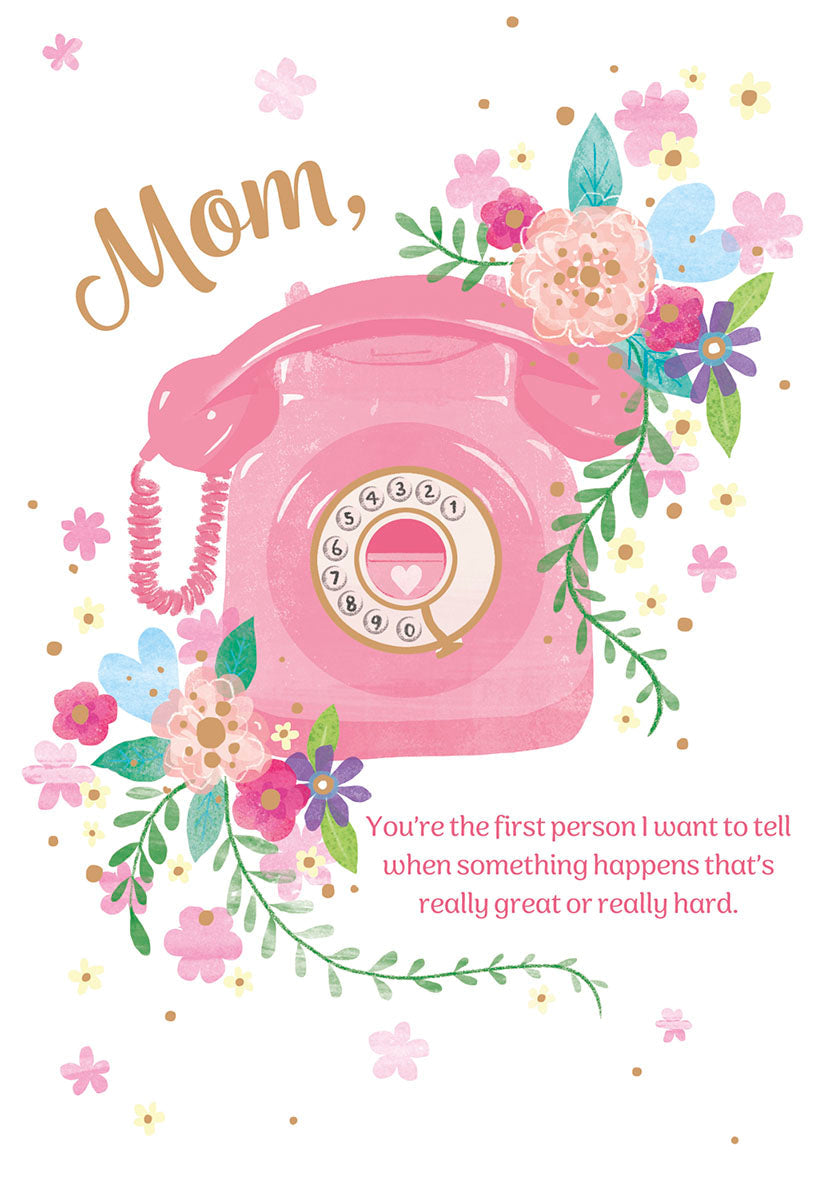 Front of a Mother's Day greeting card featuring a pink vintage rotary telephone, surrounded by colorful watercolor flowers in pink, blue, purple, and yellow. The text "Mom," is written above the phone, and below it reads: "You're the first person I want to tell when something happens that's really great or really hard."