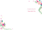Inside of a Mother's Day greeting card on a white background, with colorful watercolor floral accents in the top right and bottom left corners. The text reads: "I'm so glad to call you mine. Happy Mother's Day".