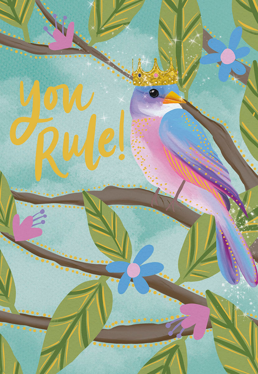 Cute Mother's Day greeting card featuring a whimsical colorful bird wearing a golden crown, perched on a tree branch with green leaves and pink and blue flowers, with the text 'You Rule!' in sparkling yellow font on a light blue background. Perfect for a queen mom.