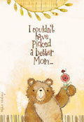 Front of a Mother's Day greeting card featuring a cute brown teddy bear holding a red flower with a ladybug. The card has a textured yellow background and the text 'I couldn't have picked a better Mom...'.