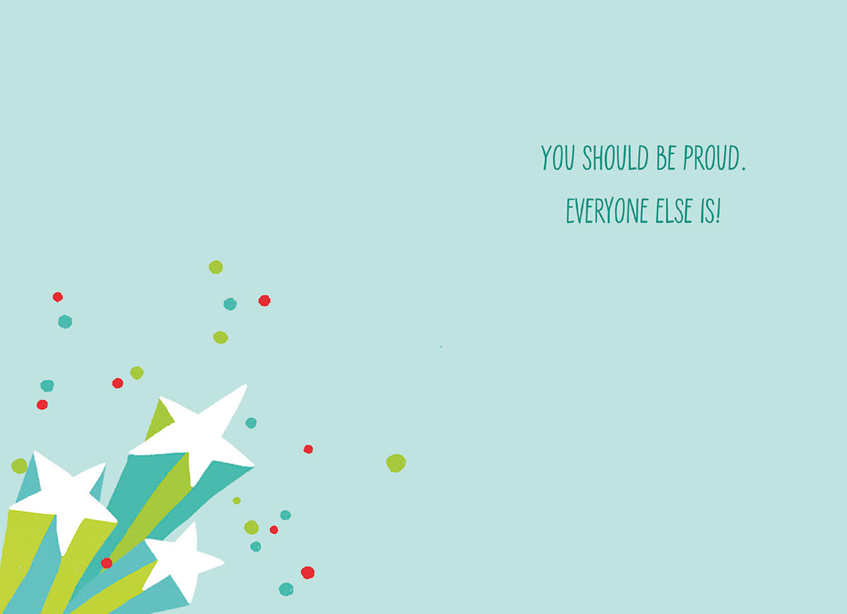 Inside of a light blue graduation card featuring white stars, colorful dots, and the encouraging message: 'YOU SHOULD BE PROUD. EVERYONE ELSE IS!'