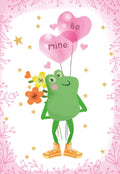 Front of a cute Valentine's Day greeting card featuring a cartoon green frog holding a bouquet of orange and yellow flowers and two pink heart balloons that say 'Be mine.' The card has a decorative pink leafy border on a white background.