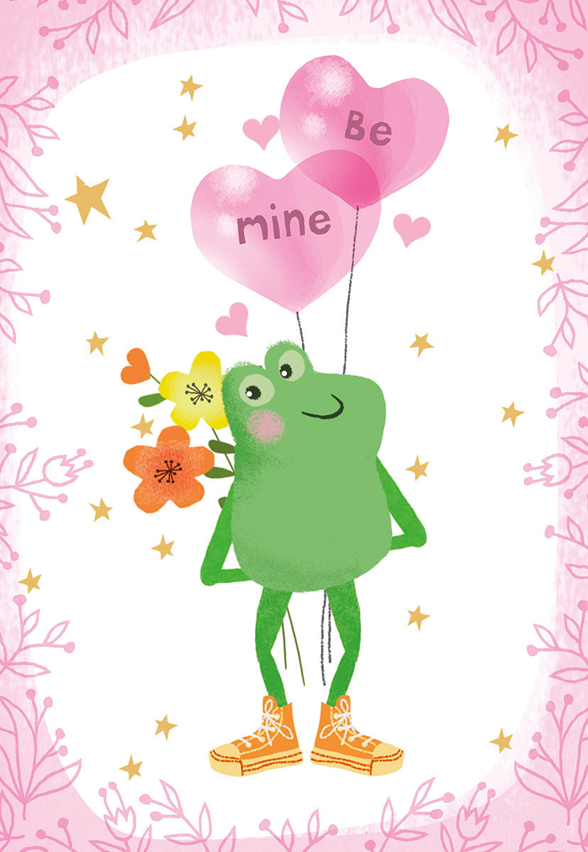 Front of a cute Valentine's Day greeting card featuring a cartoon green frog holding a bouquet of orange and yellow flowers and two pink heart balloons that say 'Be mine.' The card has a decorative pink leafy border on a white background.