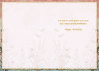 Interior of an elegant greeting card, showing a blank space for a personal message, bordered by a floral and butterfly motif. Printed message reads: 'Let joy be your guide to a year that shines with possibility! Happy Birthday'.