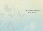 Inside of an inspiring birthday card showing a serene blue sky with faint butterfly illustrations, featuring the uplifting message 'YOU ARE TRULY LIMITLESS. HAPPY BIRTHDAY'.