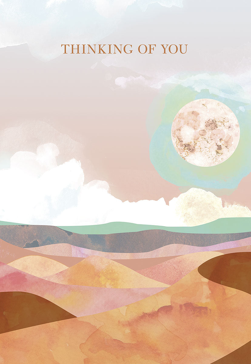 Front of an encouraging watercolor desert greeting card. Features a serene landscape with soft pink, orange, and blue hues, a full moon, and subtle clouds, with the text 'THINKING OF YOU'.