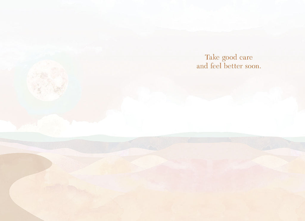 Inside of a heartfelt get well greeting card, revealing a subtle watercolor desert landscape background and the encouraging message 'Take good care and feel better soon.' in elegant script.