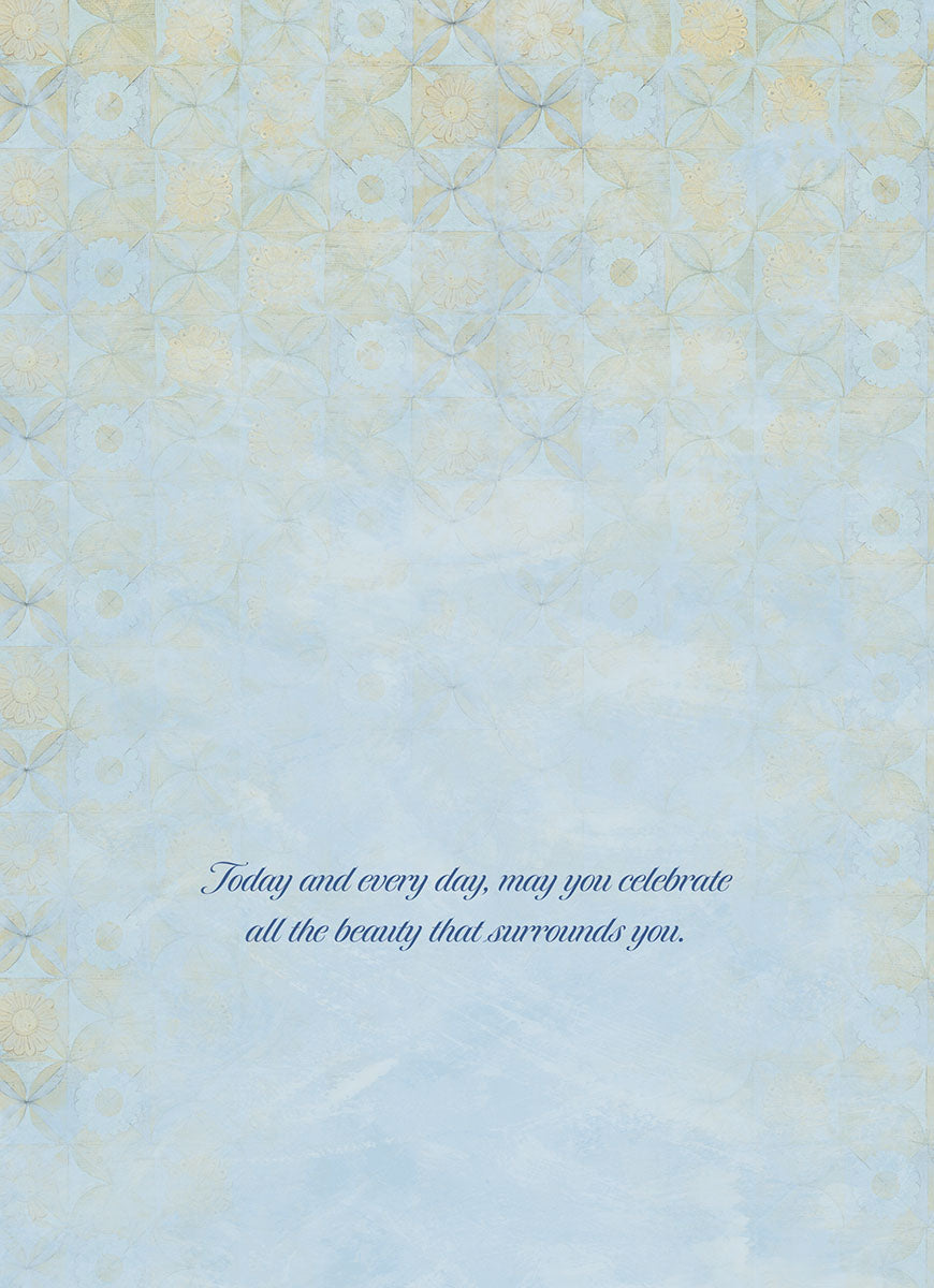 Inside view of a thoughtful greeting card with a delicate blue and gold patterned background. The message reads: 'Today and every day, may you celebrate all the beauty that surrounds you.'