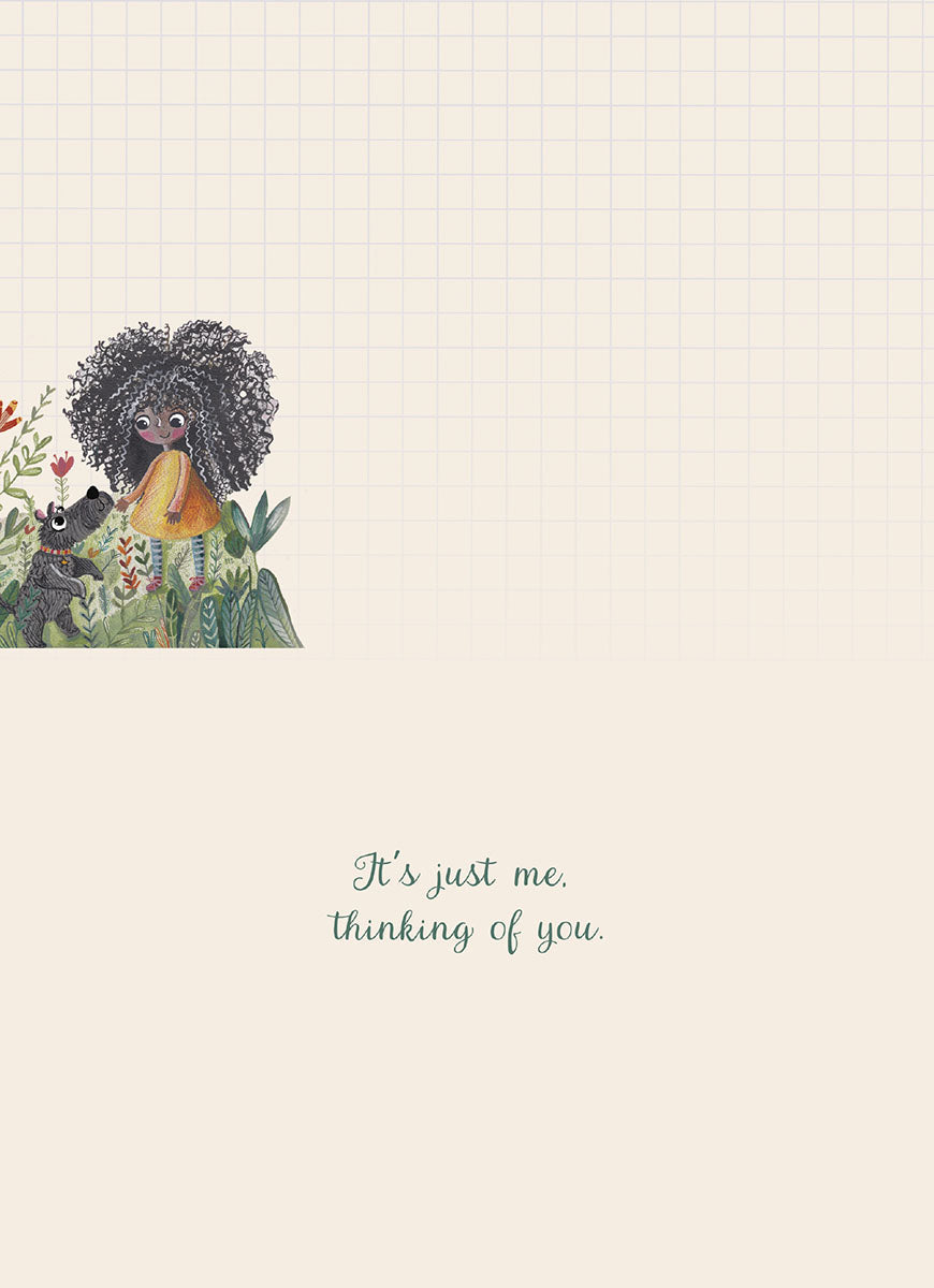 Inside view of a thoughtful friendship card with a heartfelt message 'It's just me. thinking of you.' The bottom left corner shows the illustration of the girl and dog among flowers on a grid-patterned background.