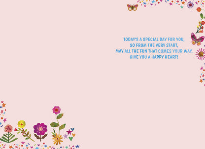 Inside of a birthday card with a sweet rhyming message about fun and a happy heart, decorated with flowers and butterflies.