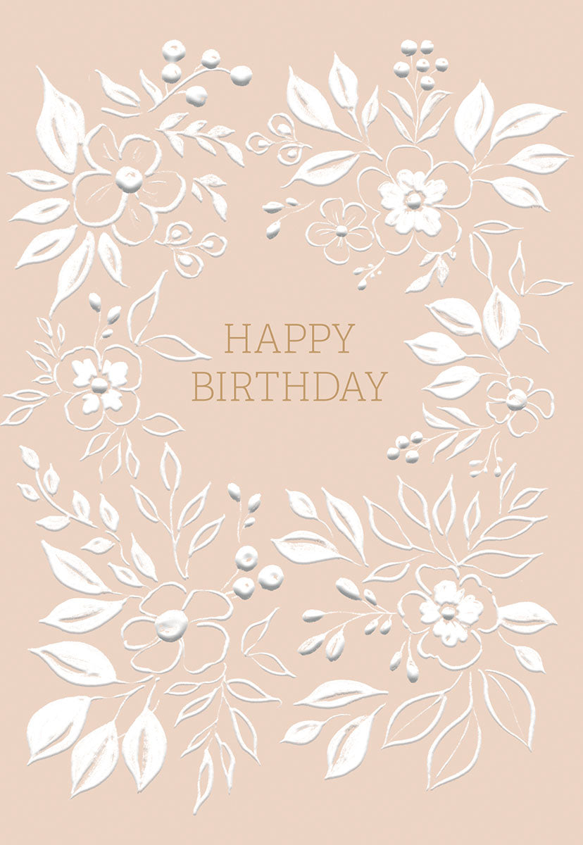 Elegant blush pink birthday greeting card with embossed white floral wreath design and gold 'HAPPY BIRTHDAY' lettering.