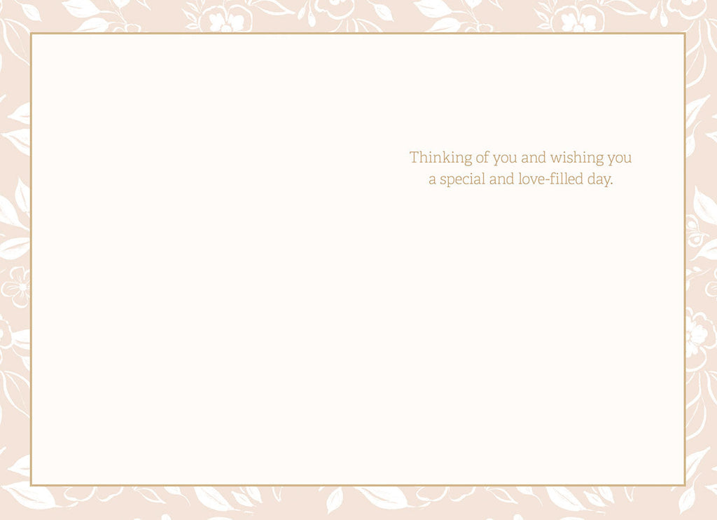 Inside of a heartfelt floral birthday card featuring a light pink patterned border and the message 'Thinking of you and wishing you a special and love-filled day.'