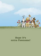 Inside of a lighthearted greeting card showing the top half with the same three watercolor dogs, butterflies, and wildflowers under a blue sky, transitioning to a green background with the message 'Hope it's extra Pawsome!'