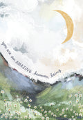 Front view of an inspiring greeting card featuring abstract artwork with a golden crescent moon, mountains, and daisies. The card reads 'you are an AMAZING human being'.